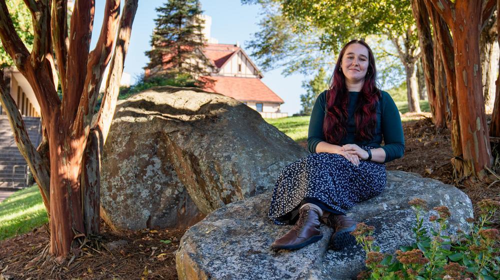allie sitting on a rock